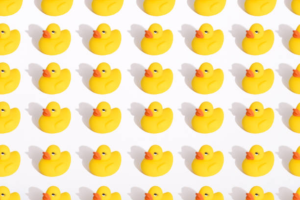 istock pattern of toy yellow ducklings on white background with shadow 1308799952