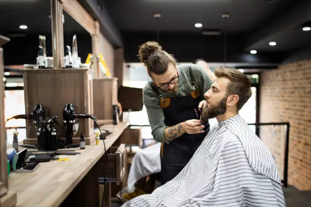 Photo of Client during beard shaving in barber shop