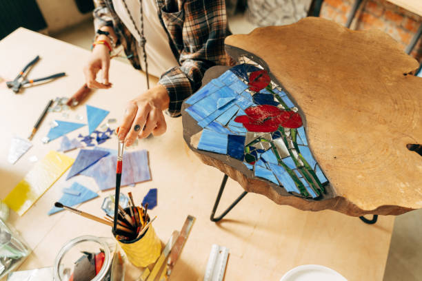 istock Artist holding tweezers and making mosaic while spending time at workplace 1308802003