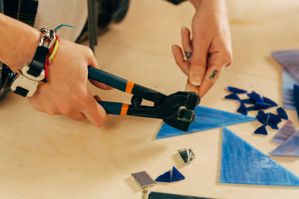 istock Woman making mosaik at the wooden table at the studio 1308802014