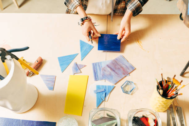 istock Female hands laying out a mosaic element on the table while making mosaik 1308802024