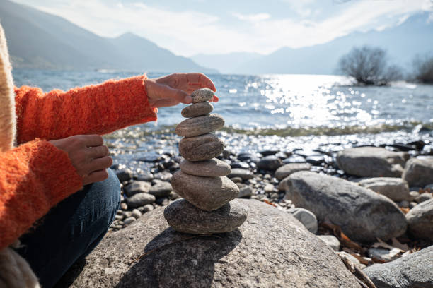 Detail of person stacking rocks by the lake Detail of person stacking rocks by the lake, shot in Ticino Canton, Switzerland.
People life balance concept stack rock stock pictures, royalty-free photos & images