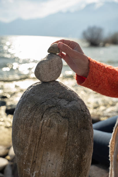 istock Person stacking rocks by the lake, Ticino 1308802365