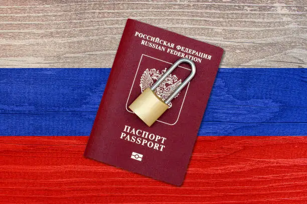 Passport of the Russian Federation and padlock on the background of the Russian flag
