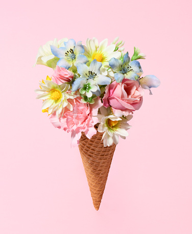 Beautiful bouquet in ice cream cone on pink