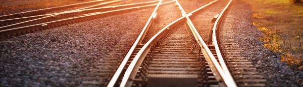 Railway track in the evening in sunset Railway track in the evening in sunset. Panoramic view on the railroad switch. railway track stock pictures, royalty-free photos & images