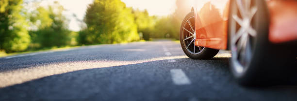 istock Red car on asphalt road in summer 1308804710
