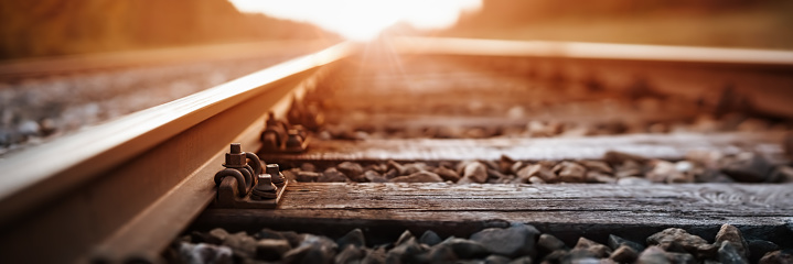 Railway track in the evening in sunset. Panoramic view on the railroad switch.