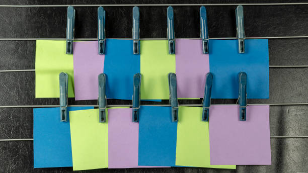 istock The paper sticky notes hanging from clothespins. 1308804871