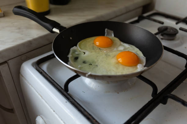 istock cooking scrambled eggs for a healthy breakfast 1308805240
