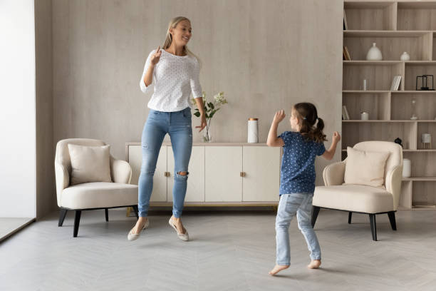 istock Happy mother dance with cute little daughter 1308806593