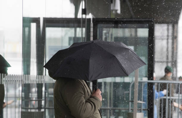 istock umbrella as protection against snow in winter 1308811136