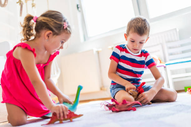 istock Children playing with toy dinosaurs 1308811147