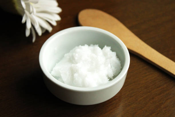 istock Natural coconut oil in a bowl, top view 1308813334