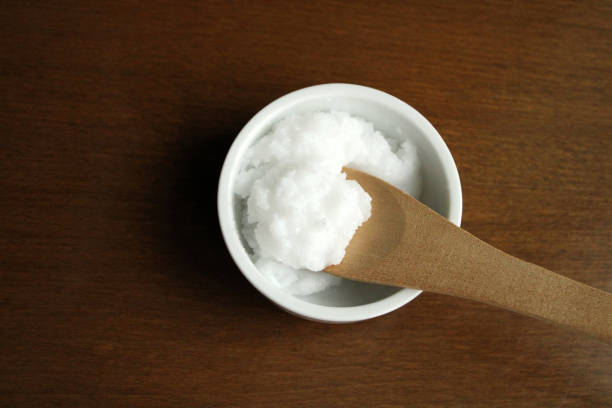 istock Natural coconut oil in a bowl, top view 1308813365