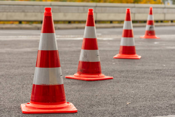istock Traffic pylons in traffic orange with reflective stripes 1308813636