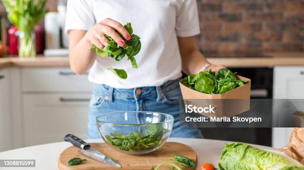 Close Up Woman In White Tshirt Cooking Salad With Motion Effect At Home Kitchen Process Of Cooking Healthy Food Vegetable Salad Concept Menu Recipe Book Banner Stock Photo - Download Image Now