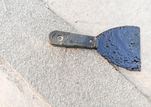 istock brush tool of black coating paint for rooftop ceiling 1308817426