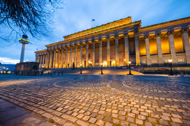 St George's Hall in Liverpool lights up yellow to celebrate National Day of Reflection by Marie Curie, marking one year since lockdown began in the UK St George's Hall in Liverpool lights up yellow to celebrate National Day of Reflection by Marie Curie, marking one year since lockdown began in the UK town hall government building photos stock pictures, royalty-free photos & images