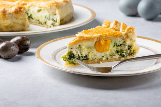 istock Torta Pasqualina. Traditional Italian savory Easter pie with spinach, chard, ricotta and whole eggs on gray background. 1308819942