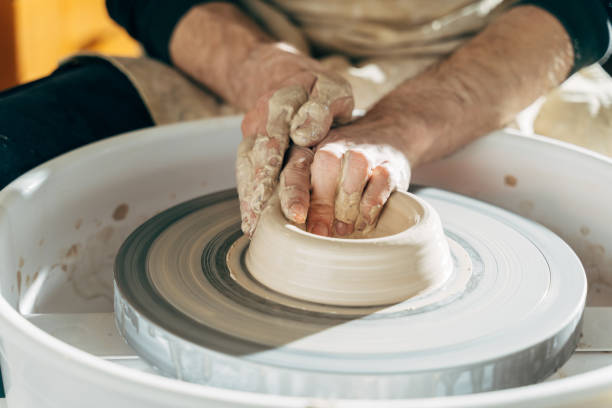 istock Professional man using mechanic pottery made earthenware for show in sculpture culture 1308823798