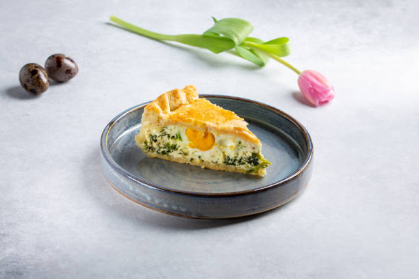 istock Torta Pasqualina. Traditional Italian savory Easter pie with spinach, chard, ricotta and whole eggs on gray background. 1308824335