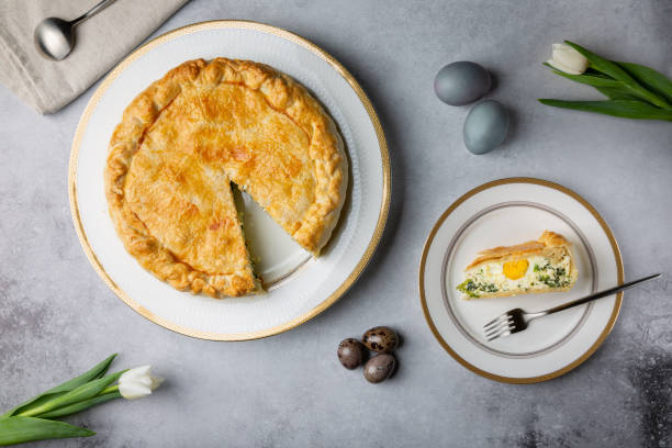 istock Torta Pasqualina. Traditional Italian savory Easter pie with spinach, chard, ricotta and whole eggs on gray background. Top view. 1308824661
