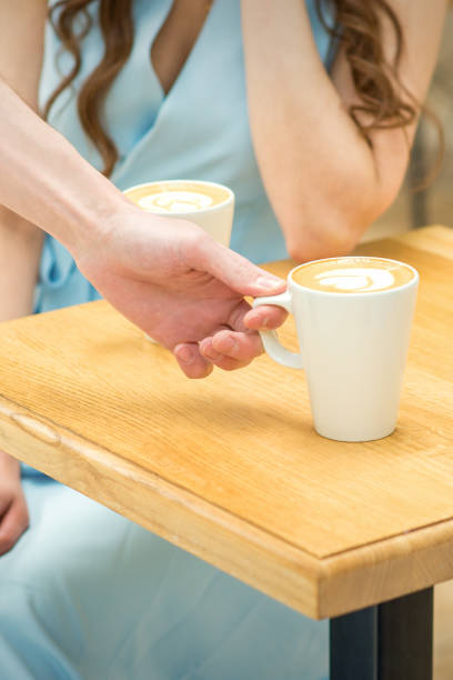 istock Waiter puts a cup of coffee 1308825774
