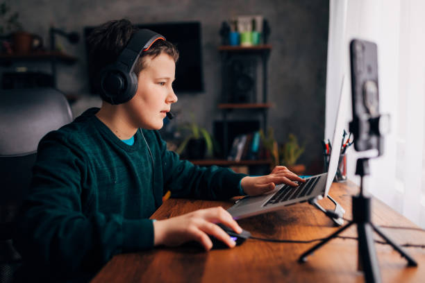 istock Modern boy, converted his hobby into side hustle. Now he have income while playing games and vlogging 1308825892