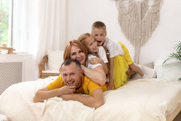 istock Cheerful family having fun together lying on a bed 1308826819
