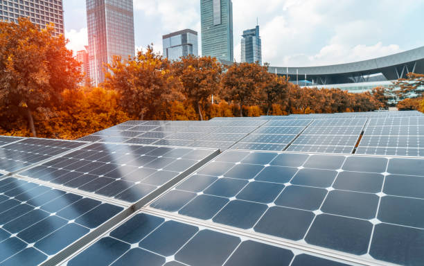 istock Ecological energy renewable solar panel plant with urban landscape landmarks 1308828817