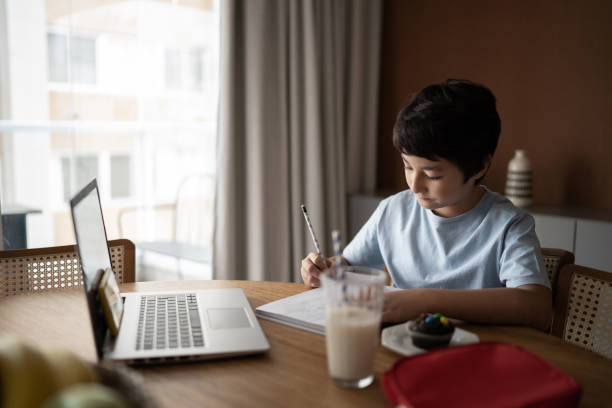 istock Teenager boy studying at home 1308829976