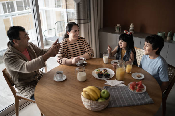 istock Father filming children during breakfast at home 1308830721