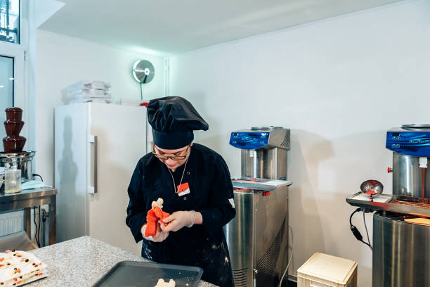 istock woman chocolatier at work in her workshop. pastry chef preparing chocolates 1308830792
