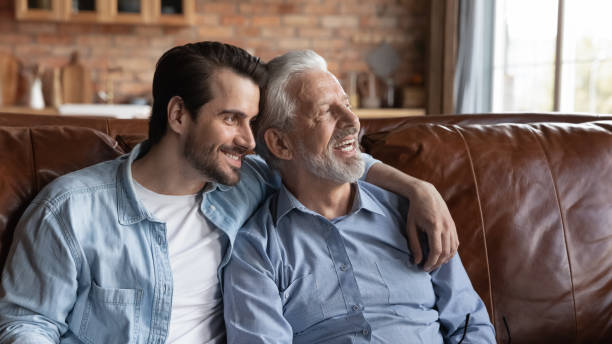 istock Happy old dad and grownup son dream at home 1308834362