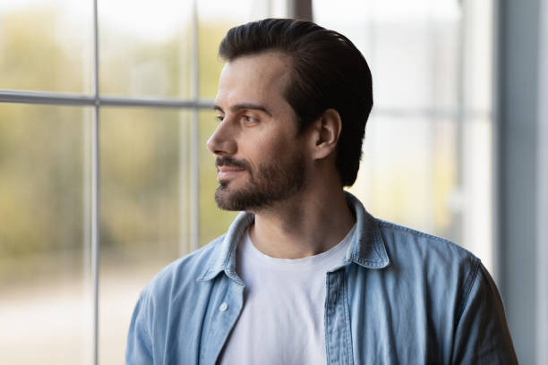 istock Pensive young man look in distance thinking 1308834372