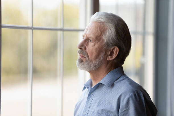 istock Unhappy older man look in distance feeling lonely 1308834394