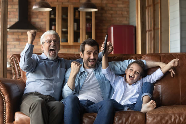 istock Overjoyed three generations of men celebrate match win 1308834418