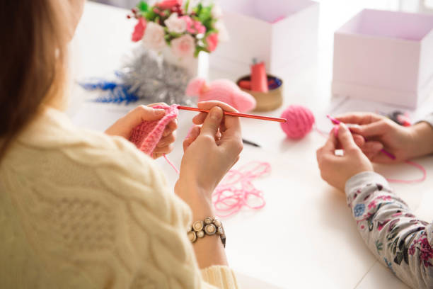 istock Young attractive girls in a crochet lesson 1308837809