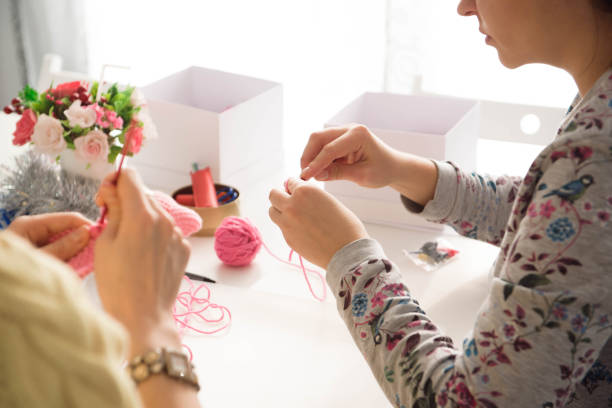 istock Young attractive girls in a knitting lesson 1308837823