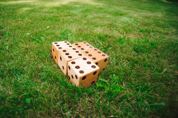 istock Outdoor games - Big dices on the green grass. 1308838302