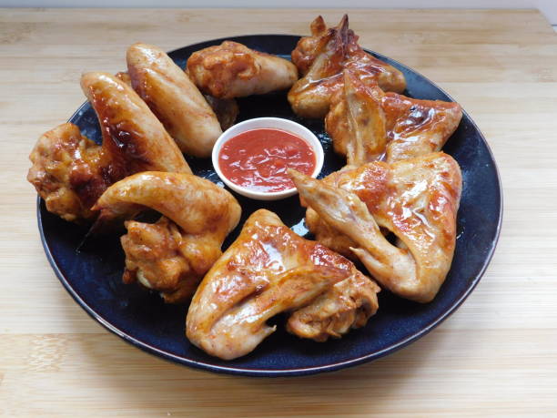 istock Barbecue chicken wings with red sauce. Rustic style. Top view, closeup 1308838570
