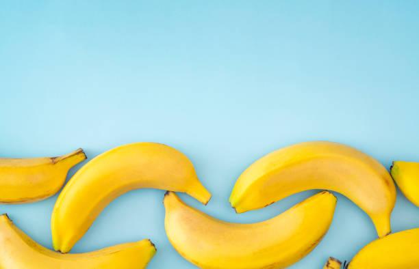 Yellow bananas on the blue background stock photo