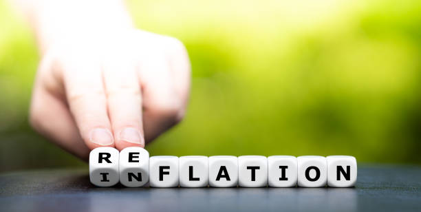 istock Hand turns dice and changes the word inflation to reflation. 1308839549