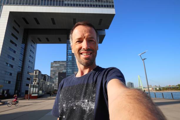 Tourist selfie in Cologne, Germany. Traveler selfie with Rheinauhafen modern district of Cologne.