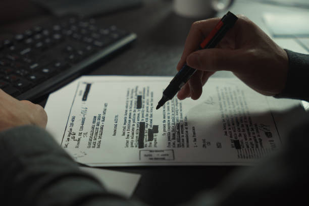 istock A man works with papers at a computer desk 1308842619