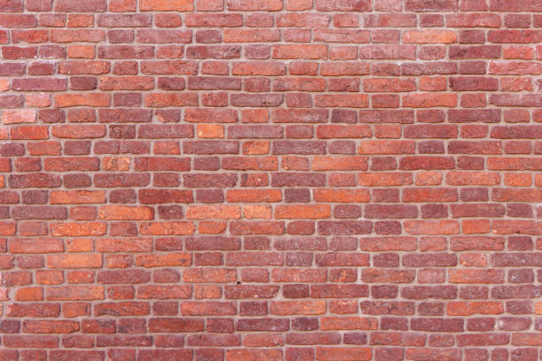 istock A wall of old, cracked bricks, with a weathered and faded surface. 1308842730