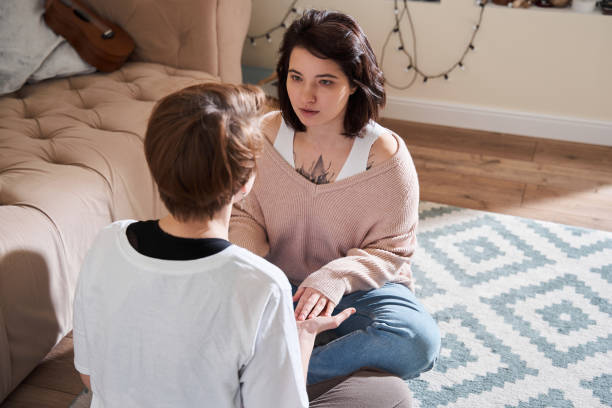 istock Lesbian couple practicing meditation exercises on the floor at home 1308843113