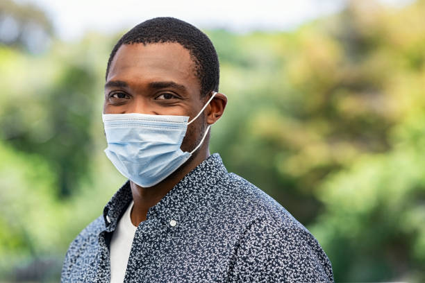 istock Black mature man in park wearing face mask 1308843455