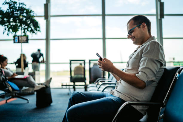 istock Man having video call on airport 1308844050